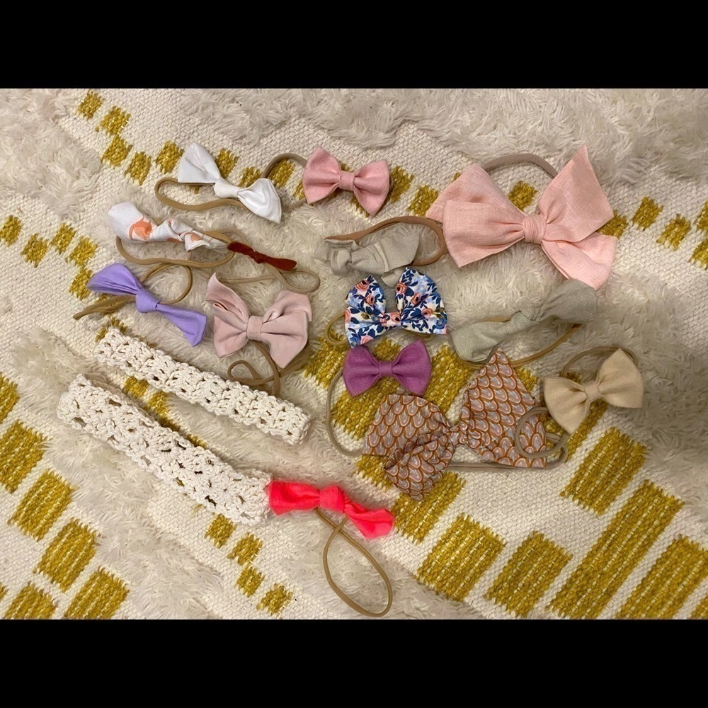 Set of 16 pink, white/cream, purple colored baby girl bows.
